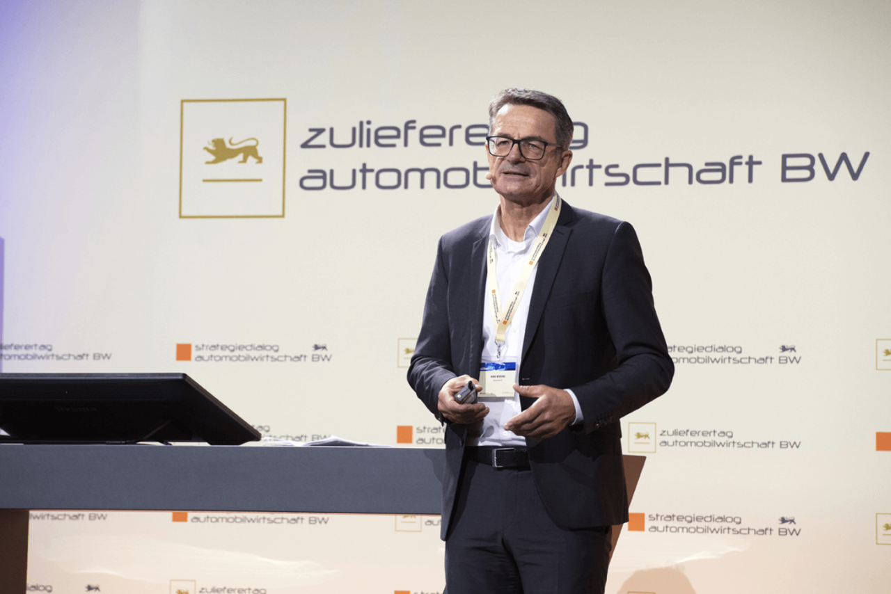 Hans Remsig, Leiter Expertenteam Automotive bei der Deutschen Bank, steht auf der Bühne beim Zulieferertag Automobilwirtschaft BW 2021 und hält einen Impuls.