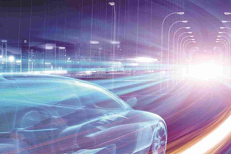 Futuristisches Bild eines schnell fahrenden Autos und einer Stadt beleuchtet in grellen bunten Farben.